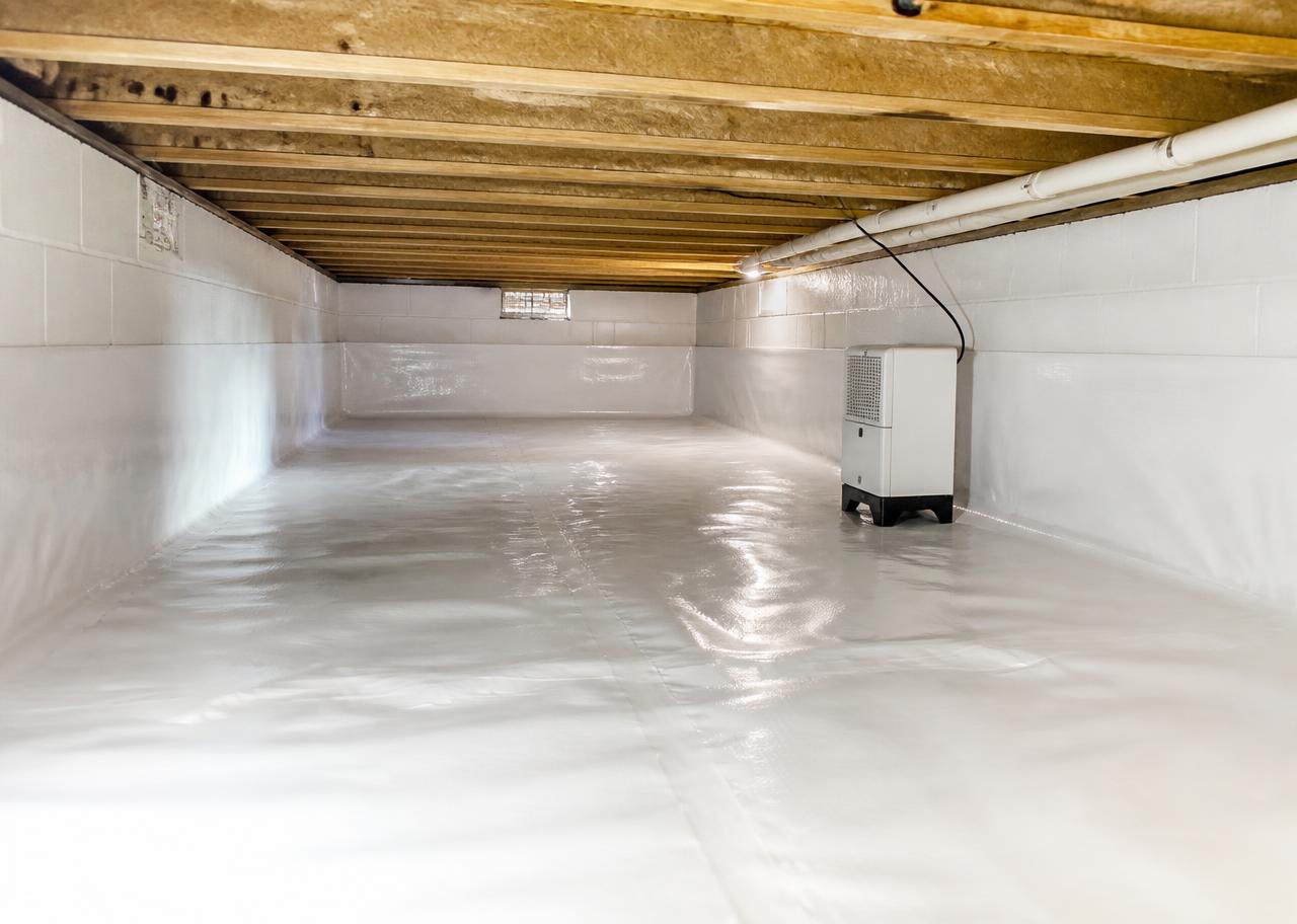 Encapsulated crawl space with sealed white vapor barrier and installed dehumidifier